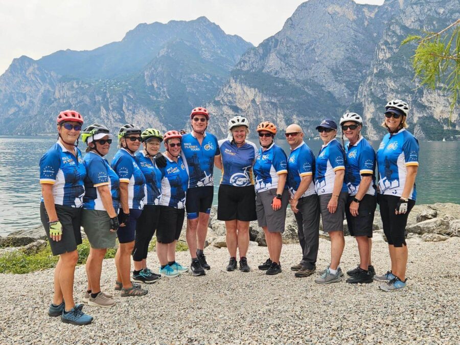 Bike group posing in front of a lake on a guided bike tour